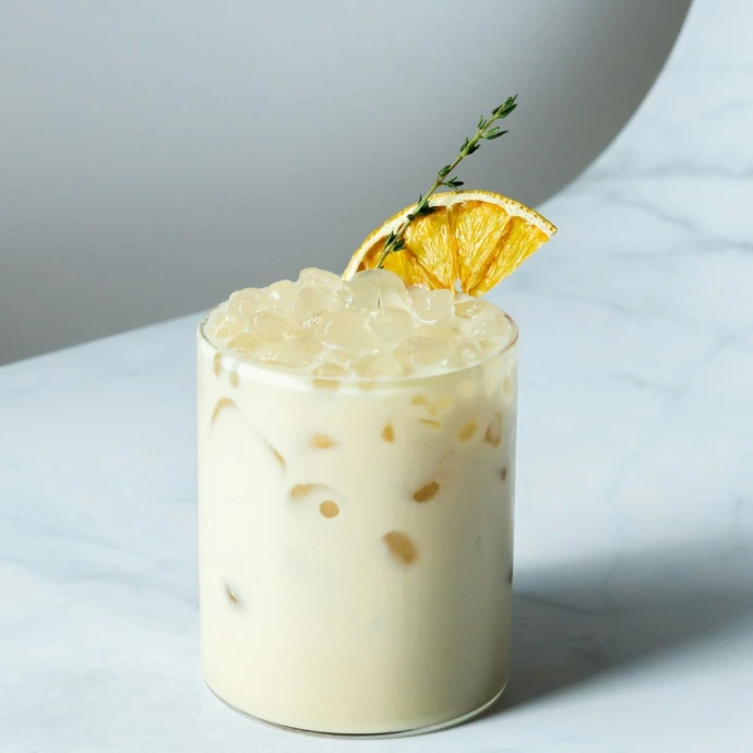 white liquid with yellow flower on top